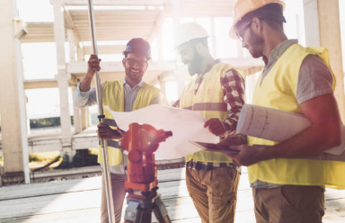 construction workers looking at plans on paper