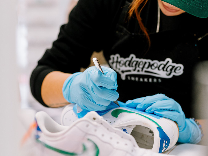 Close up of woman creating custom sneaker art