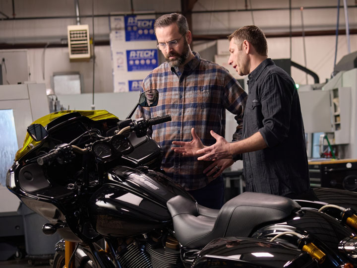 Kraus Moto owner Satya Kraus pictured with a motorcycle and one of his employees in his St. George, Utah, manufacturing facility.