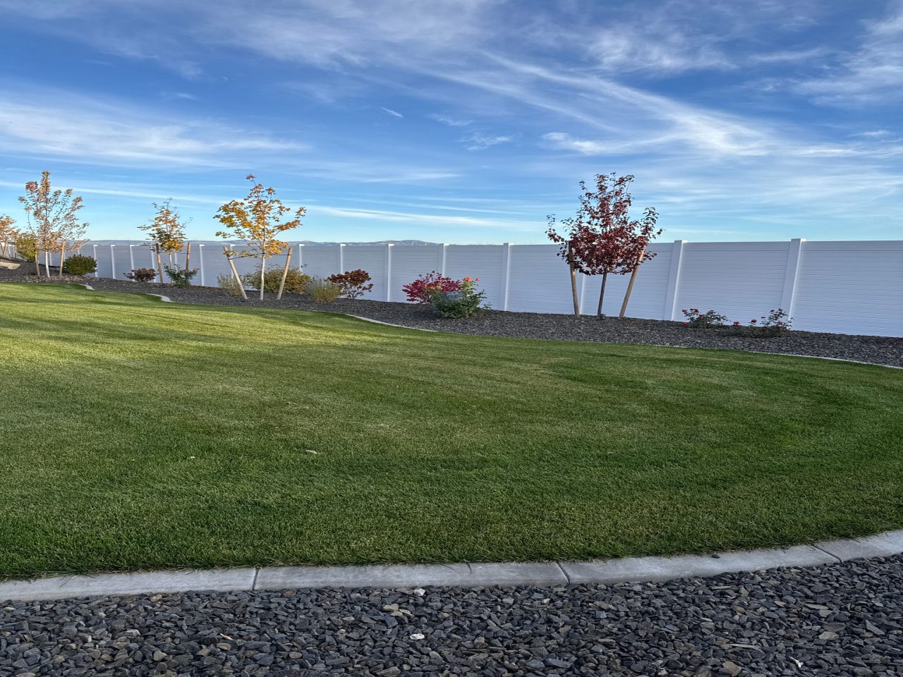 lawn and white fence